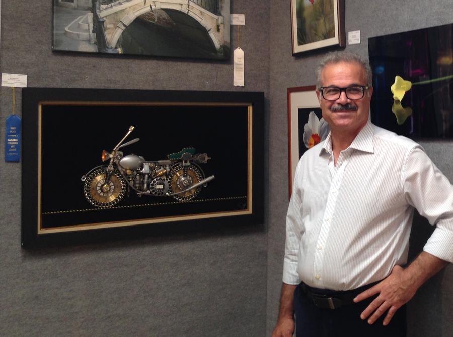 Houshang Foroutan beside his prize-winning motorbike collage