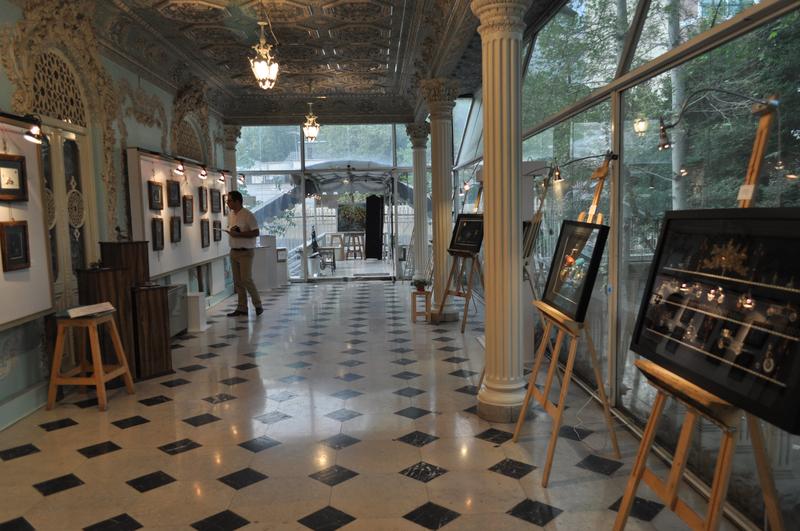 Gallery interior showing watch collages on easels